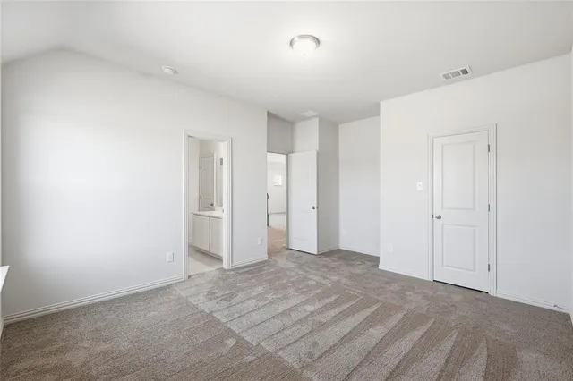 an empty room with a ceiling fan and window