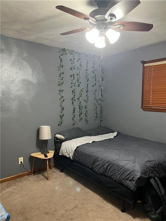 145 Coffman Road Acme, PA 15610 - Photo 16 of 37 a bedroom with a bed and a chandelier