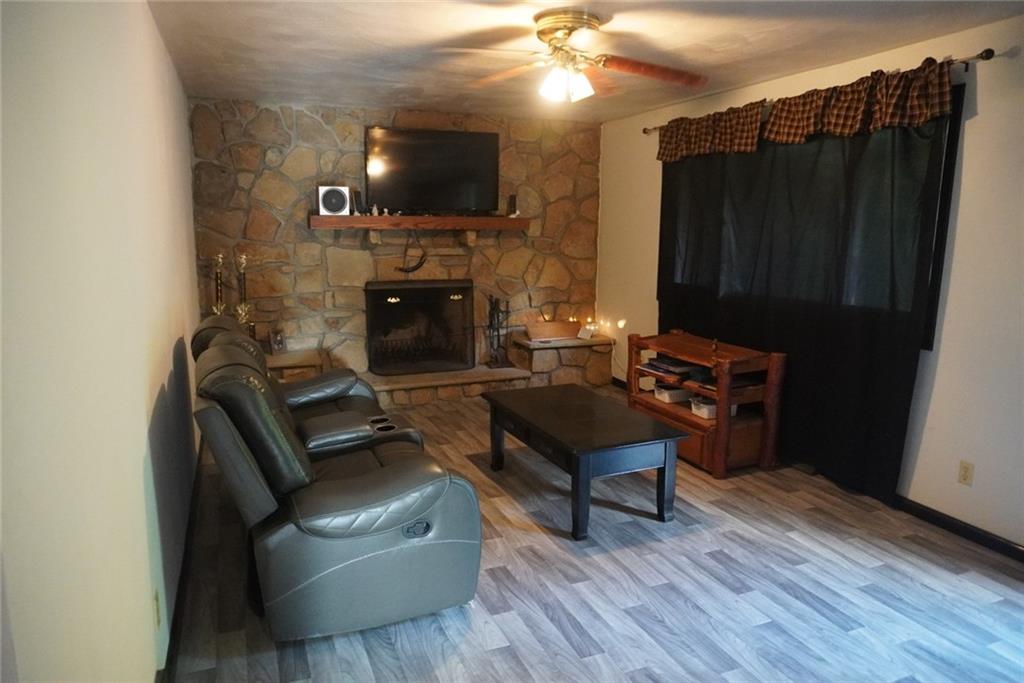 145 Coffman Road Acme, PA 15610 - Photo 2 of 37 a living room with furniture and a flat screen tv