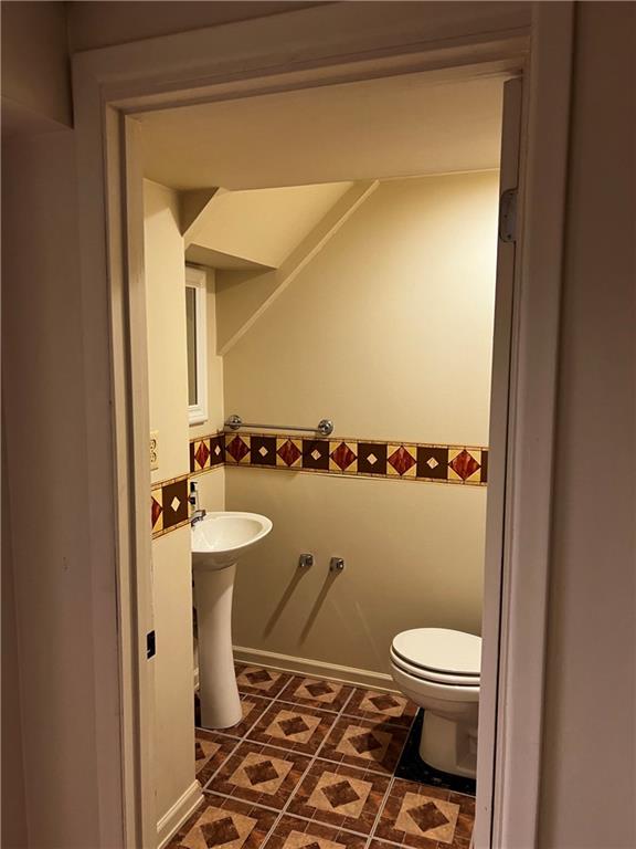 145 Coffman Road Acme, PA 15610 - Photo 22 of 37 a bathroom with a toilet a sink and mirror