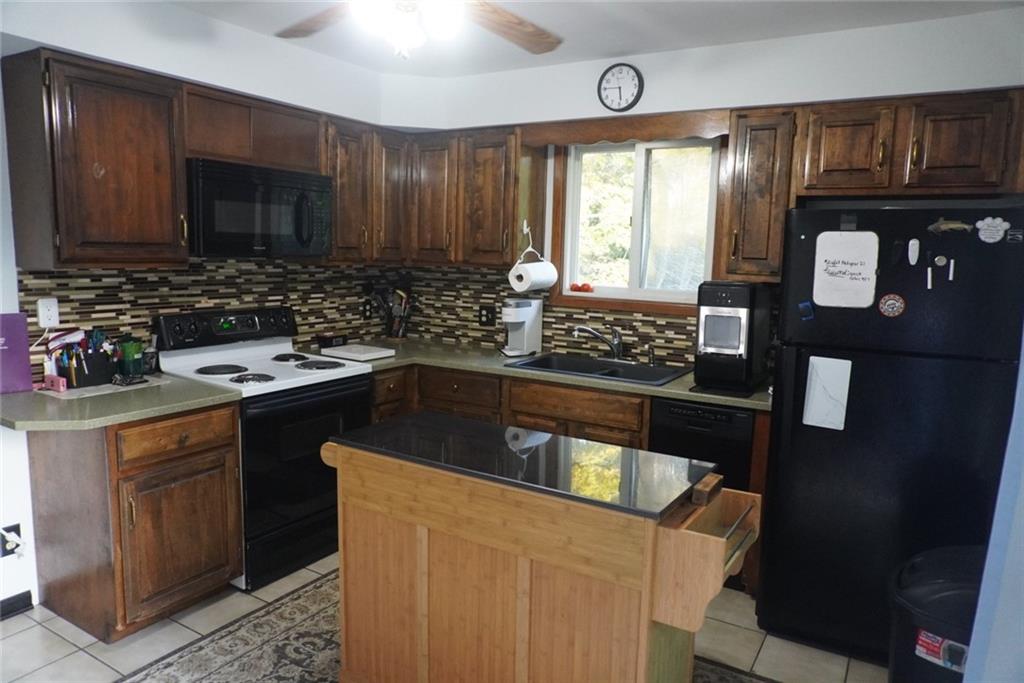 145 Coffman Road Acme, PA 15610 - Photo 7 of 37 a kitchen with a sink stove top oven and cabinets
