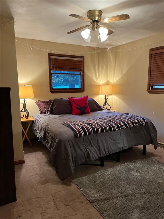 145 Coffman Road Acme, PA 15610 - Photo 8 of 37 a bedroom with a bed and a chandelier