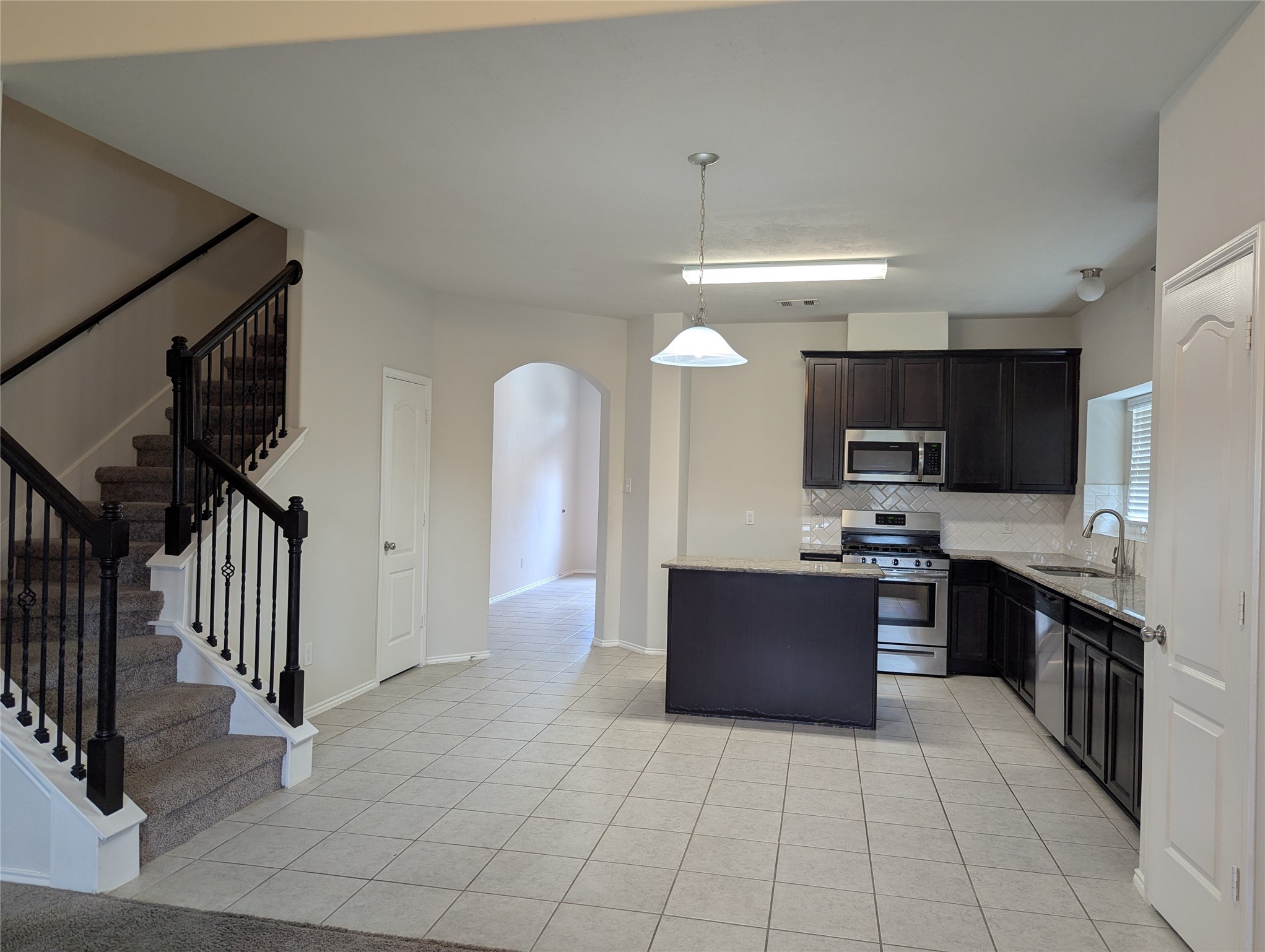 13319 Lansdown Street Rosharon, TX 77583 - Photo 7 of 22 a large kitchen with stainless steel appliances and a refrigerator