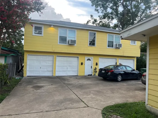 a view of a car parked in front of a house
