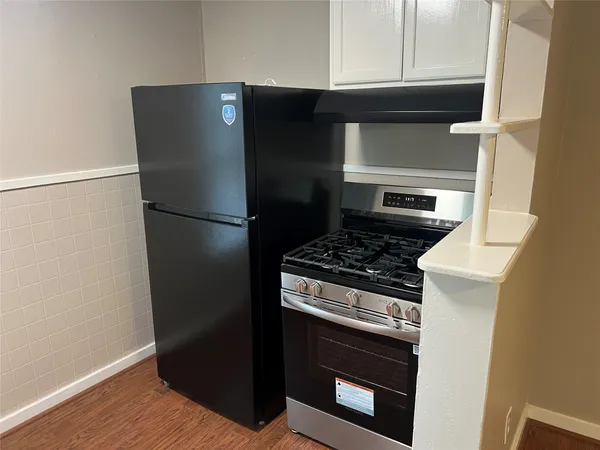 a metallic refrigerator freezer sitting in a kitchen
