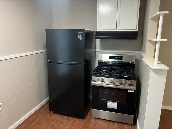 a kitchen with a stove and a refrigerator