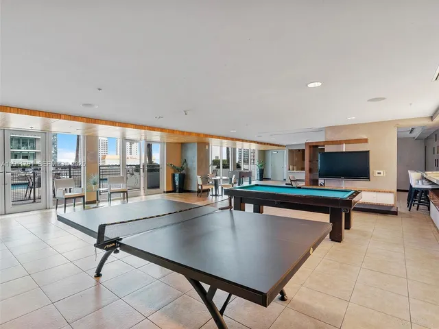 a living room with furniture pool table and dining table
