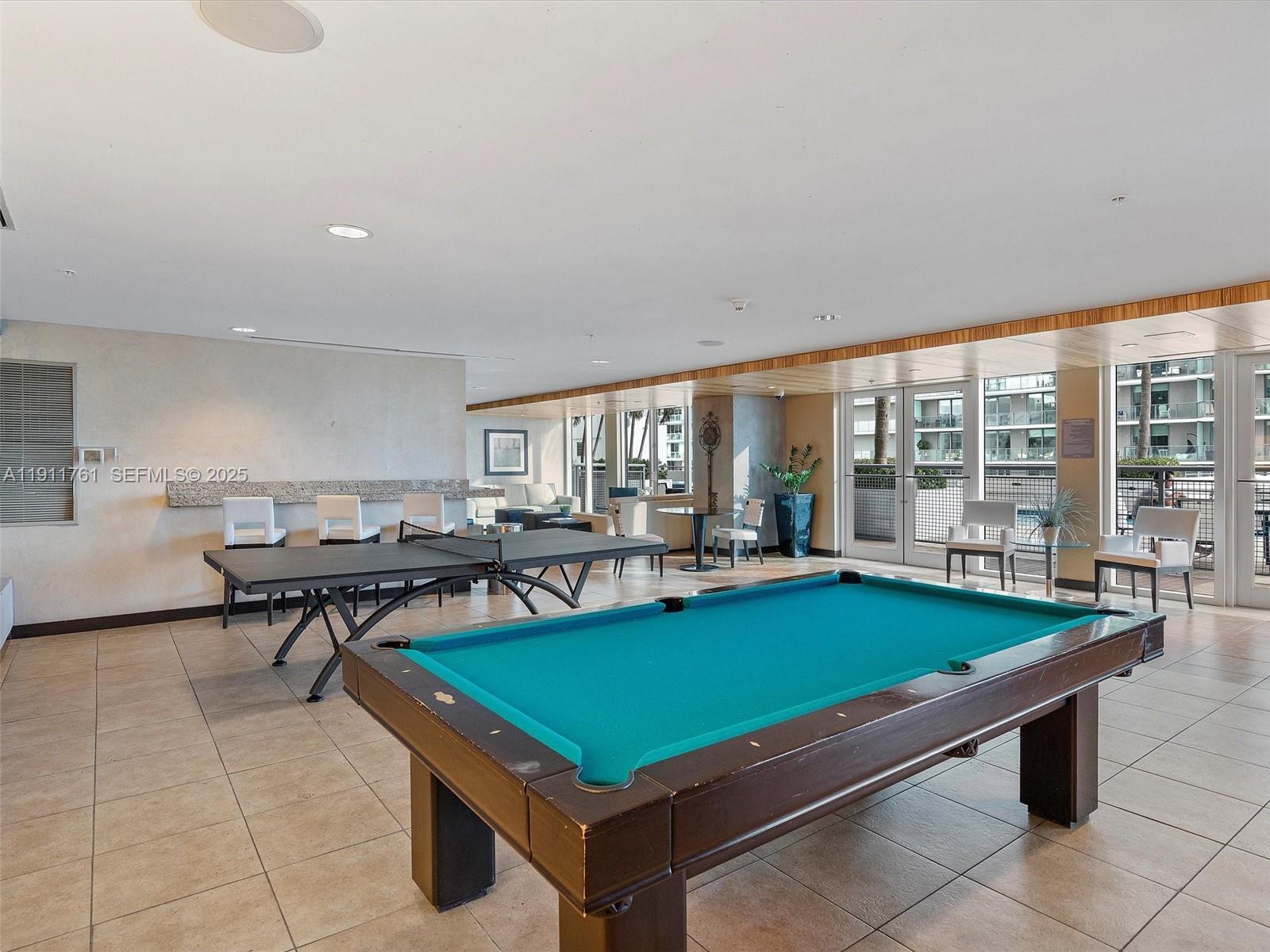 60 Southwest 13th Street, Unit 2119 Miami, FL 33130 - Photo 21 of 23 a living room with furniture pool table and dining table
