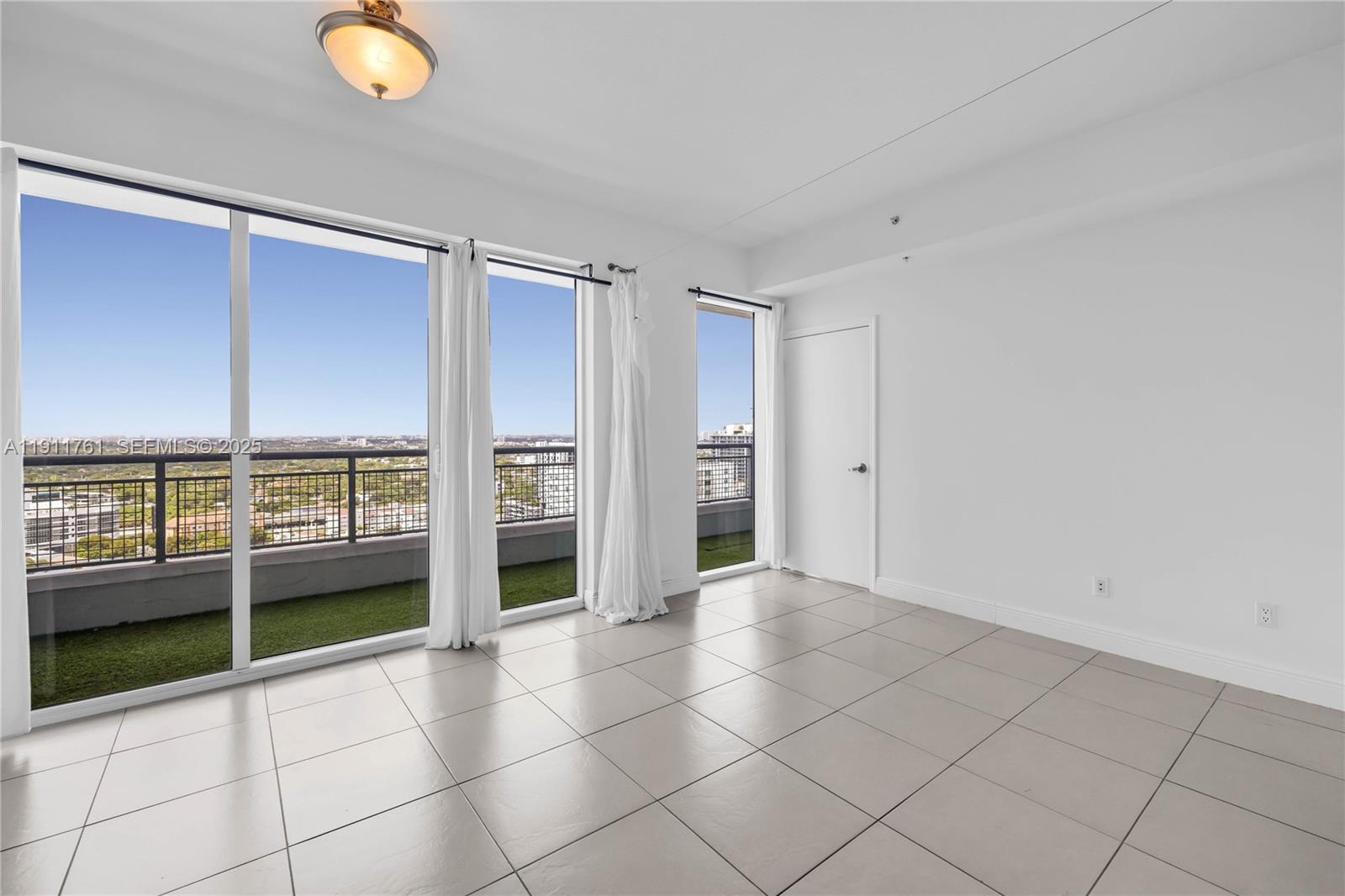 60 Southwest 13th Street, Unit 2119 Miami, FL 33130 - Photo 3 of 23 an empty room with windows