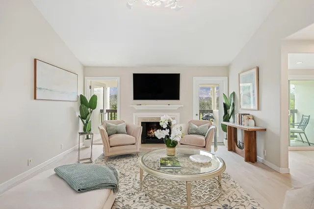 a living room with furniture a fireplace and a flat screen tv