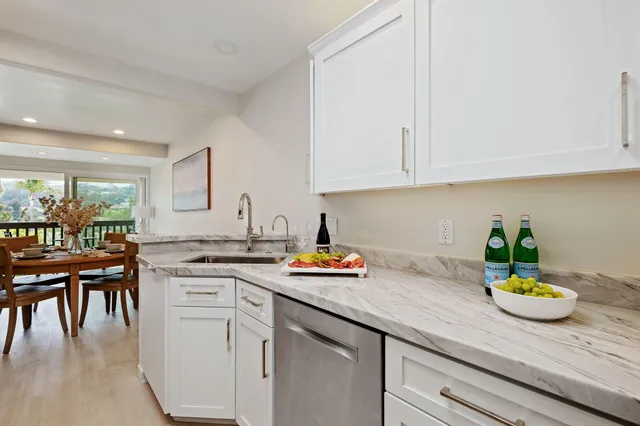 a kitchen with a sink a stove and cabinets