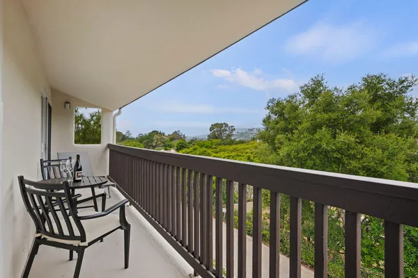 a view of a two chairs in the balcony