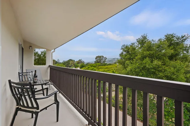 a view of a two chairs in the balcony