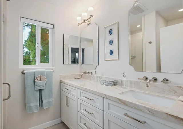 a bathroom with a sink double vanity and a mirror
