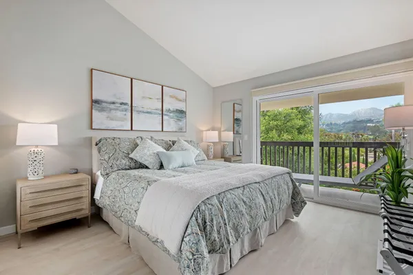 a bedroom with a bed and a large window