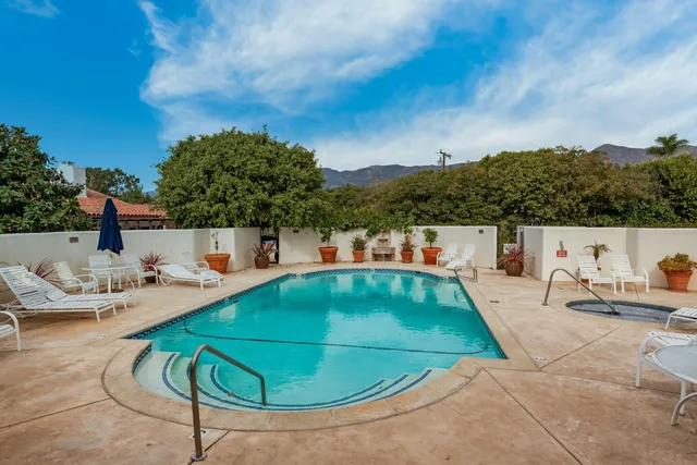 a view of a swimming pool with a patio and a yard