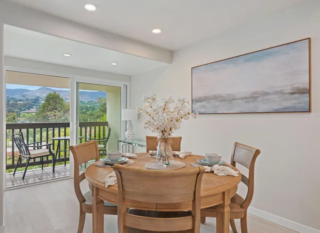 a dining room with furniture and window