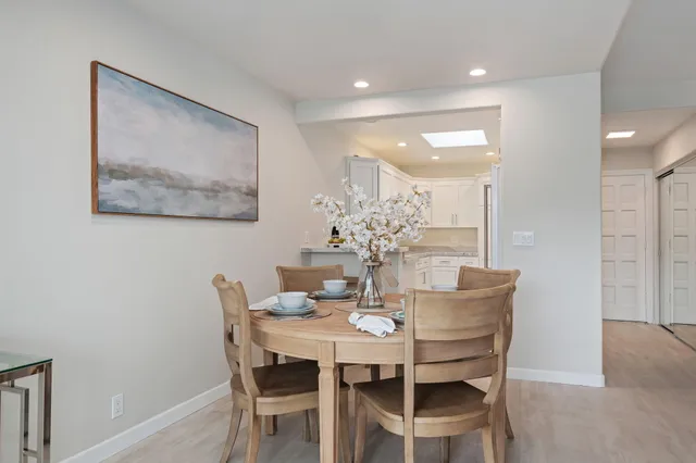 a dining room with furniture and wooden floor