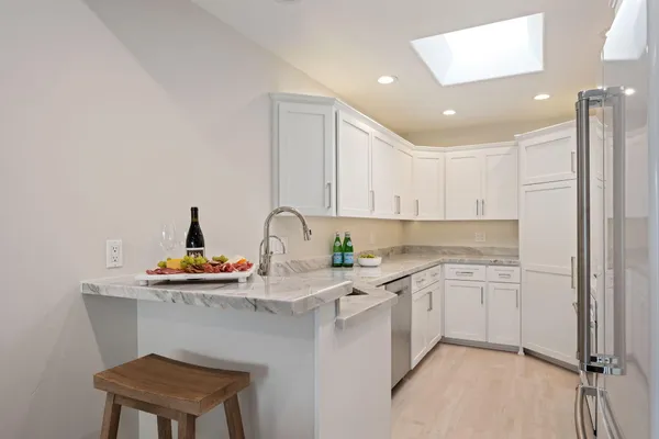 a kitchen with stainless steel appliances a sink and cabinets