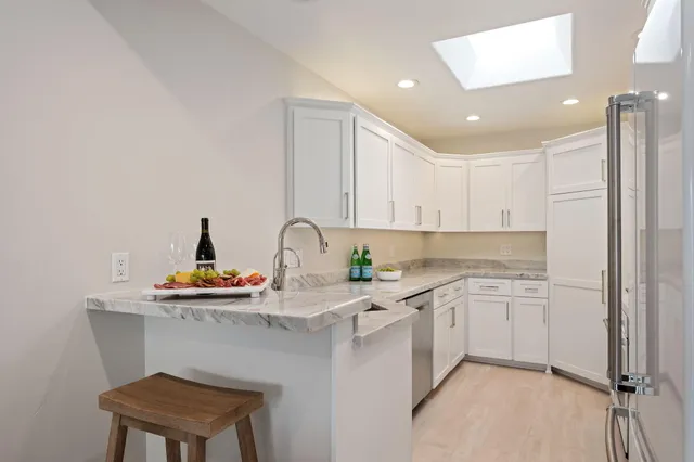 a kitchen with stainless steel appliances a sink and cabinets