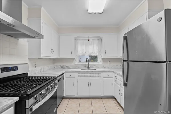 a kitchen with a sink stove and refrigerator