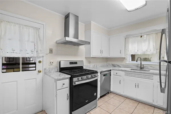 a kitchen with cabinets appliances and a counter space