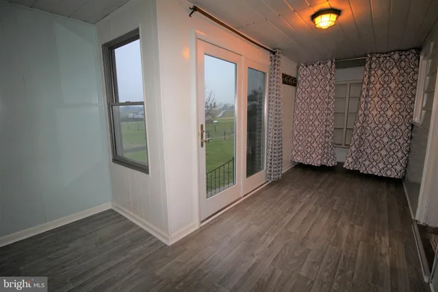 a room with wooden floor and window