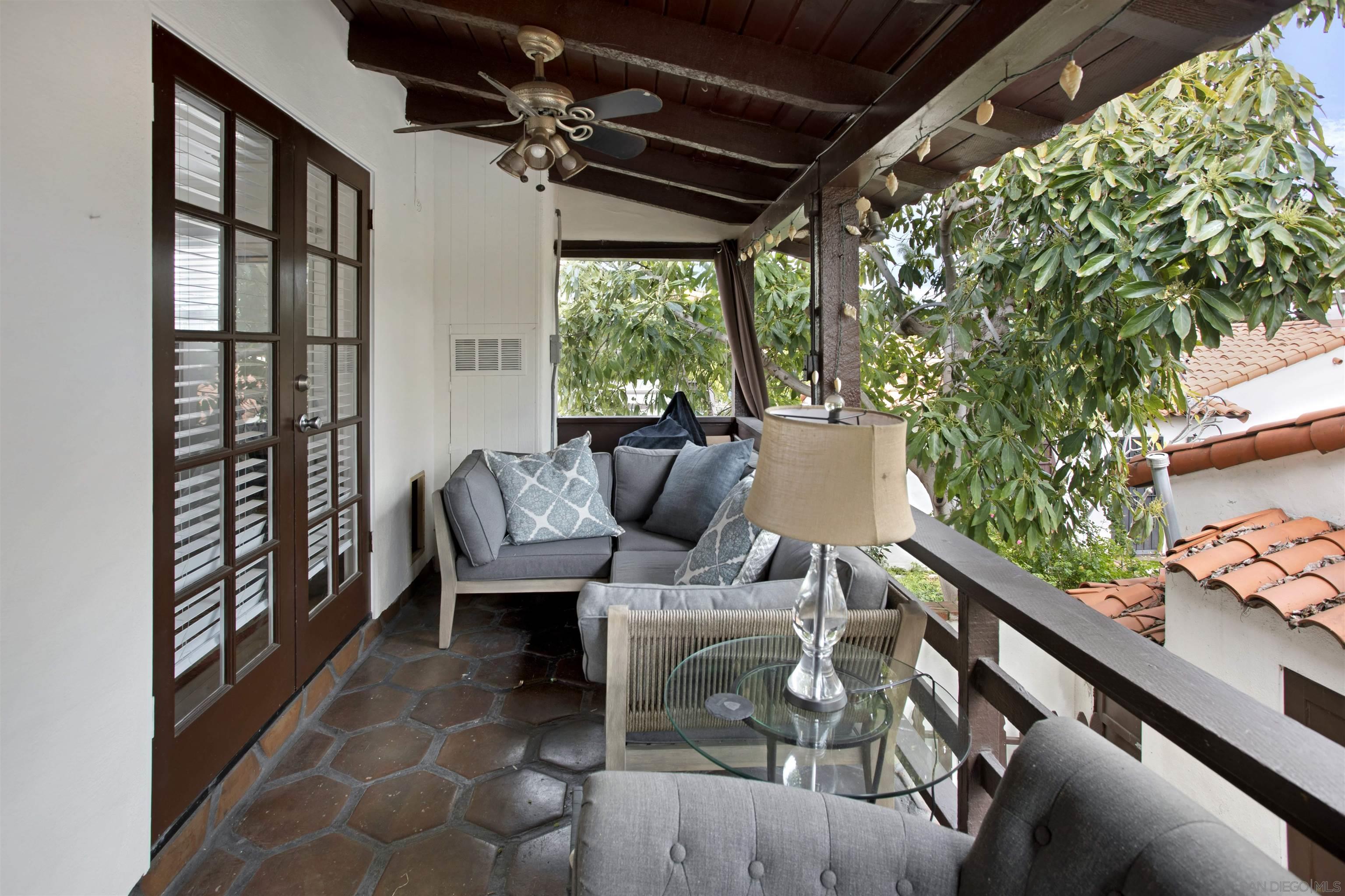 a view of balcony with couch and chairs