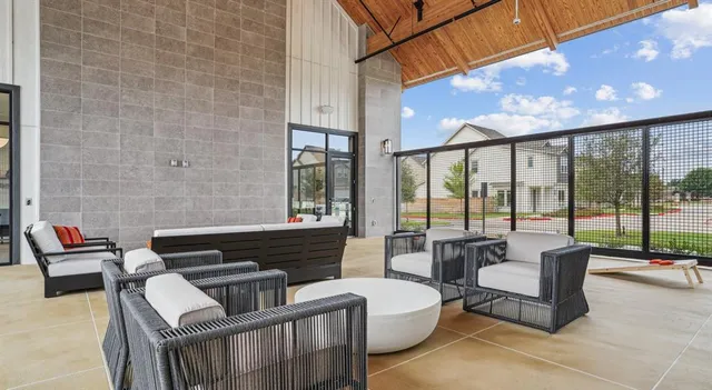 a living room with furniture and a floor to ceiling window