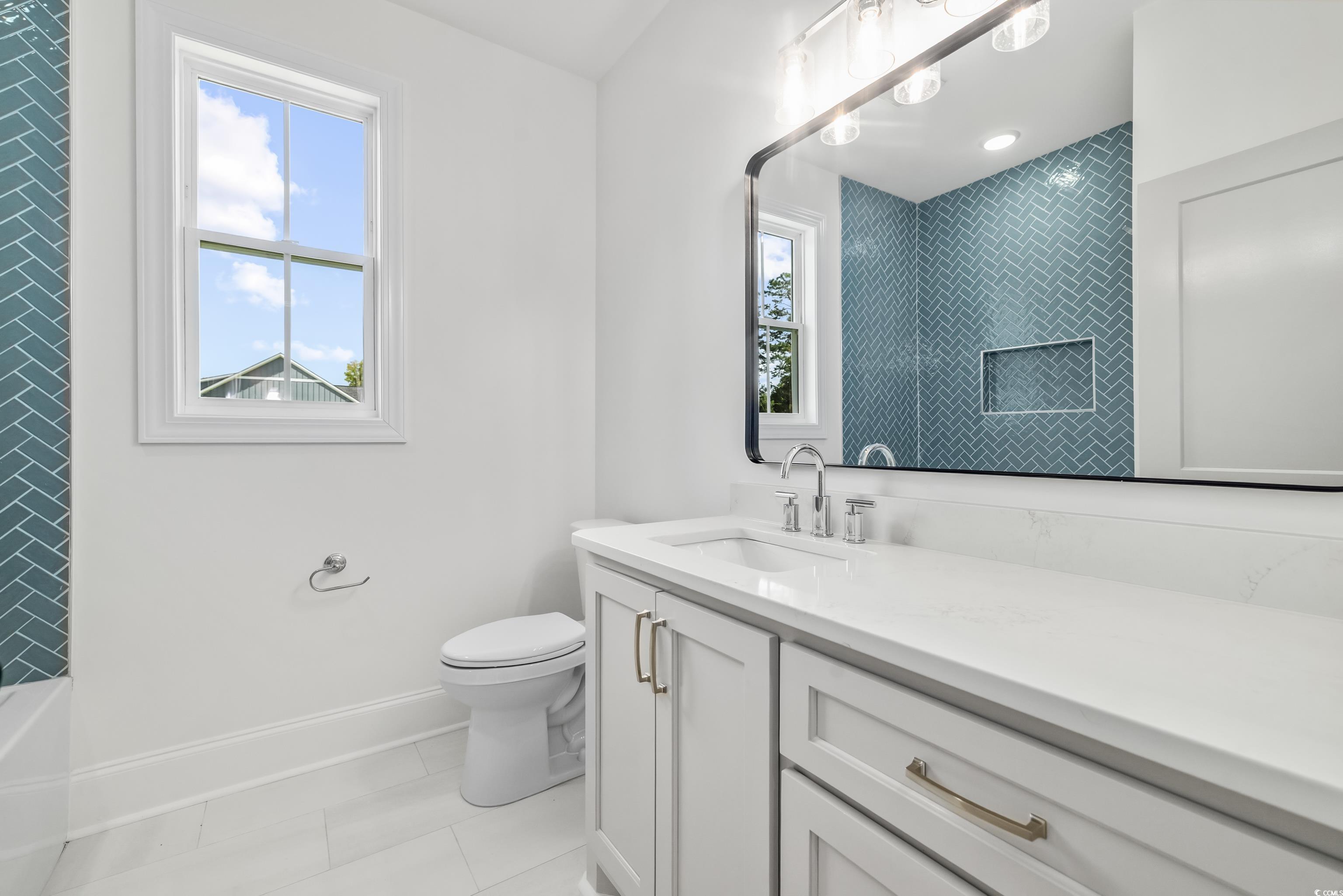 346 Ridge Road Galivants Ferry, SC 29544 - Photo 7 of 24 Full bath featuring vanity, light tile patterned floors, and shower combination