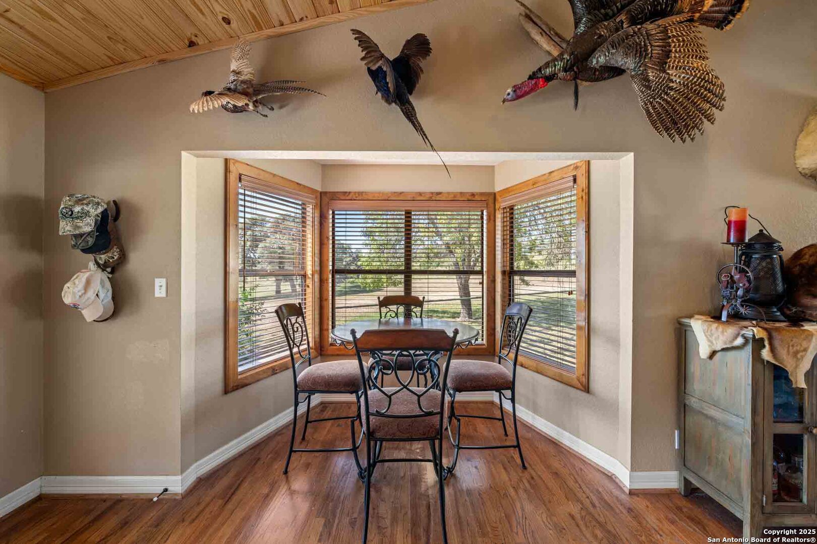 171 Flach Road Comfort, TX 78013 - Photo 36 of 91 a dining room with furniture wooden floor and a chandelier