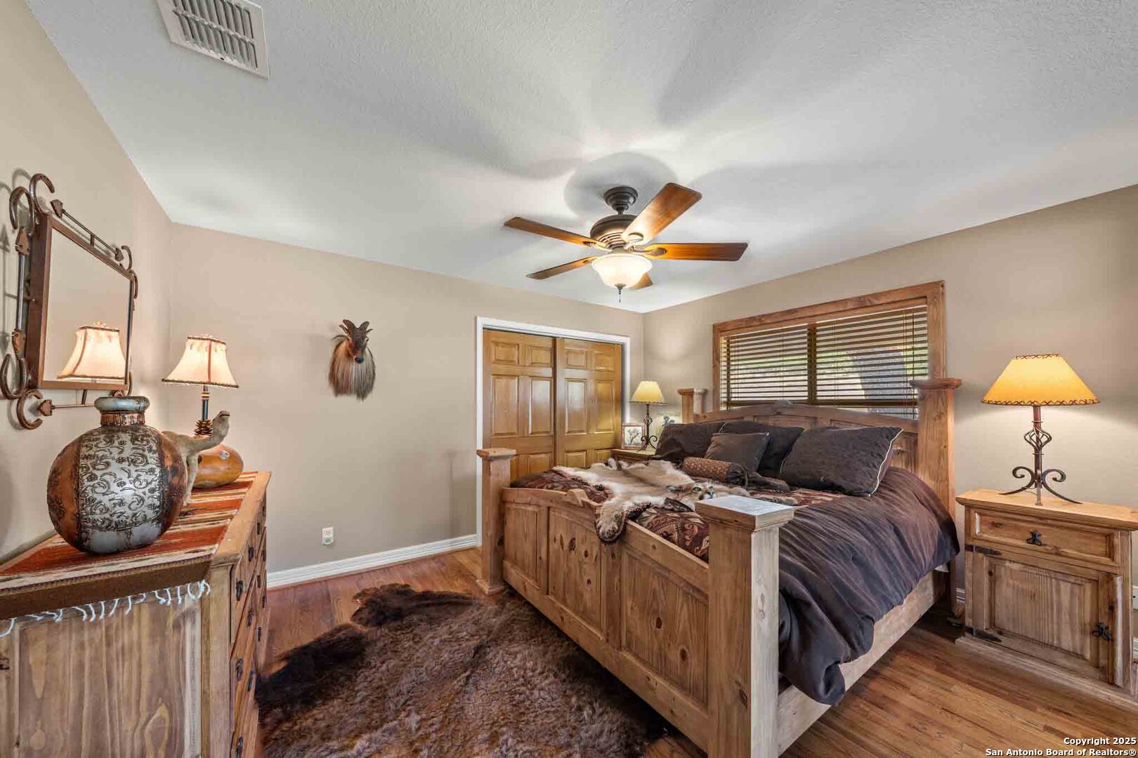 171 Flach Road Comfort, TX 78013 - Photo 39 of 91 a bed room with a bed and a chandelier