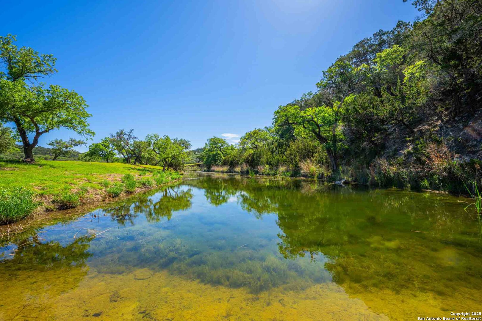 171 Flach Road Comfort, TX 78013 - Photo 59 of 91 a view of a lake with houses in the background