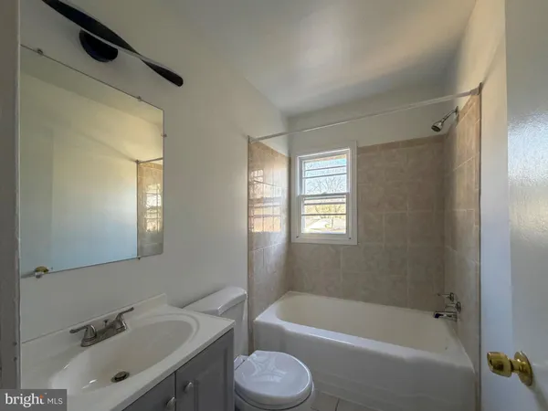 a bathroom with a sink toilet and bathtub