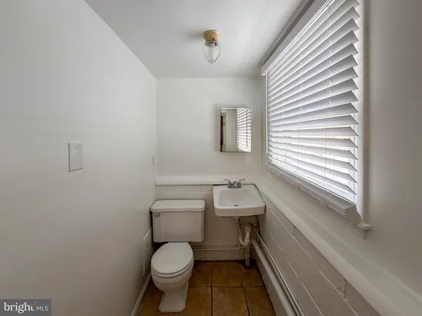 a bathroom with a toilet sink and window