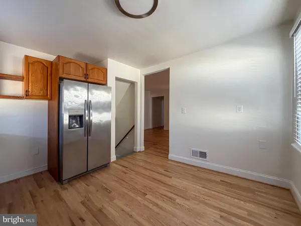 a view of a refrigerator in kitchen and wooden floor