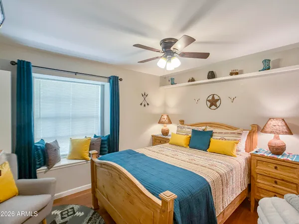 a bedroom with a bed dresser and a window