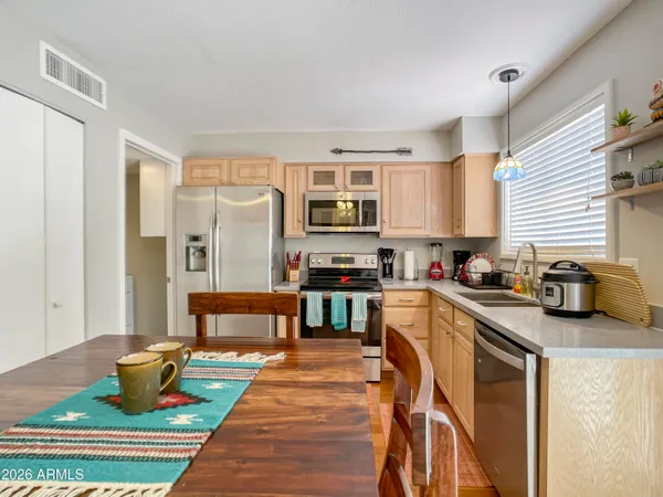 a kitchen with stainless steel appliances granite countertop a stove a sink and a refrigerator