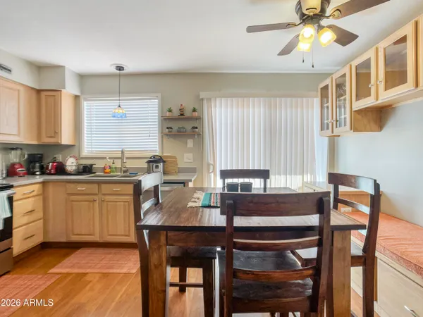 a kitchen with a dining table chairs cabinets and appliances