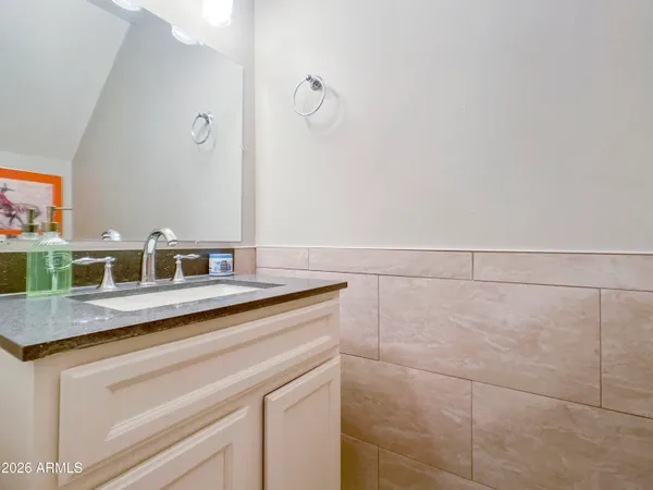 a sink with a mirror and vanity