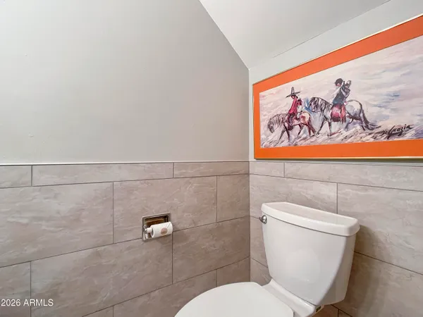 a white toilet sitting next to a shower