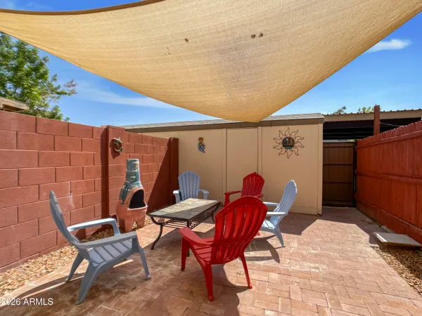 a backyard of a house with table and chairs