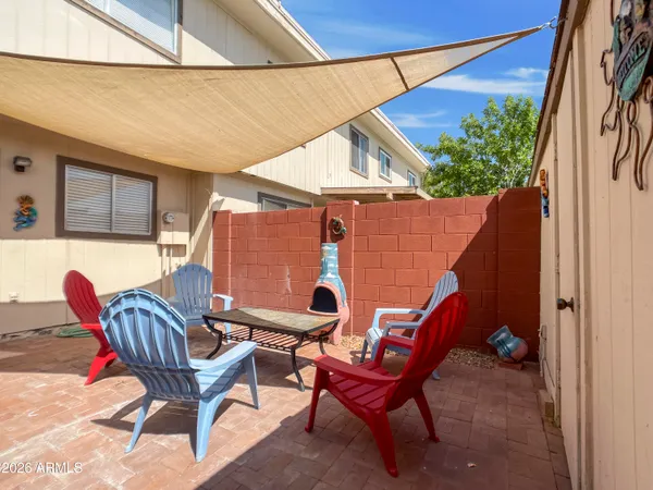 a balcony with couple of chairs and couch