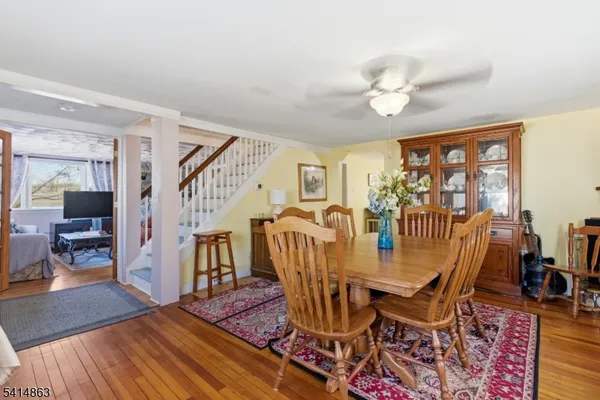 a view of a dining room with furniture wooden floor and chandelier
