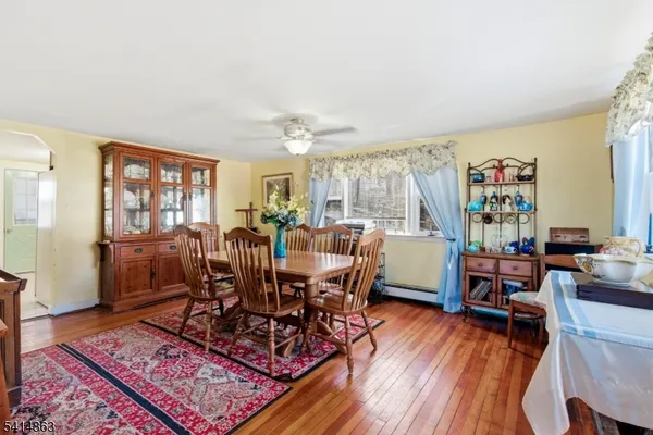 a view of a livingroom with furniture window and wooden floor