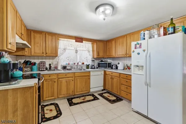 a kitchen with stainless steel appliances granite countertop a refrigerator sink and cabinets
