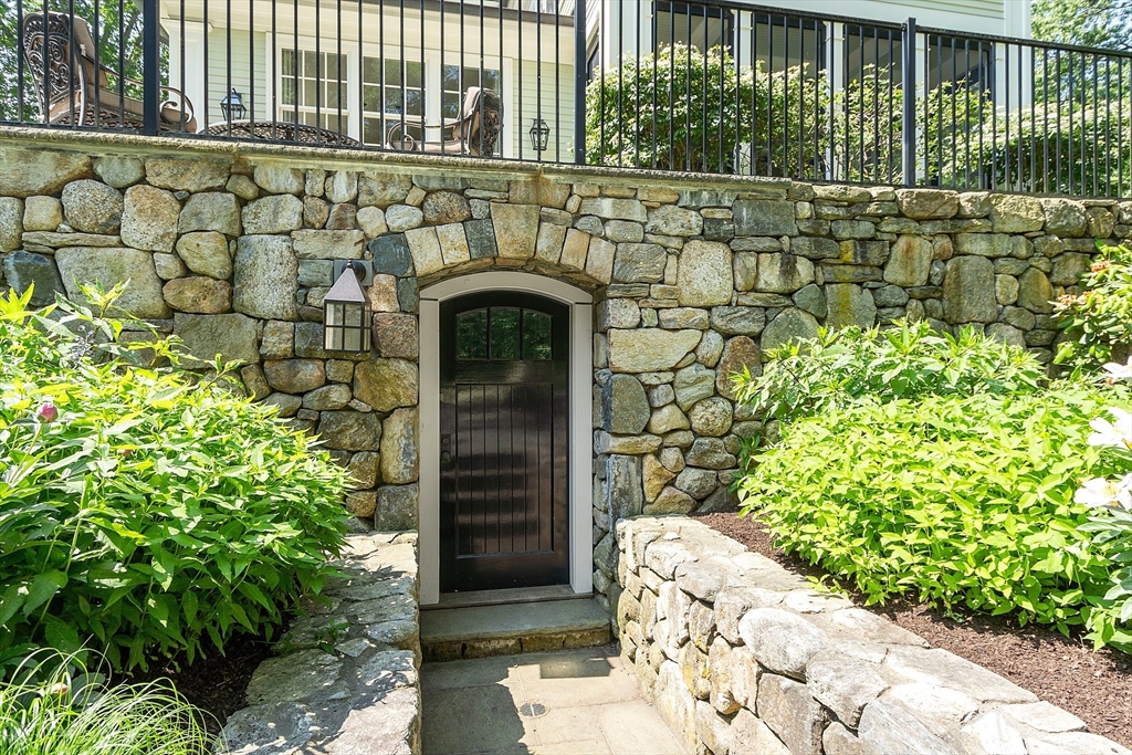 76 Red Coat Lane Concord, MA 01742 - Photo 11 of 42 a front view of a house with a garden