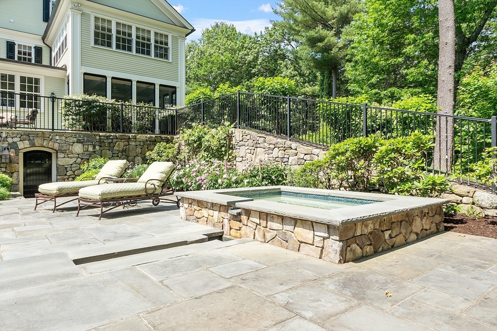 76 Red Coat Lane Concord, MA 01742 - Photo 12 of 42 a view of a patio with couches and a fire pit