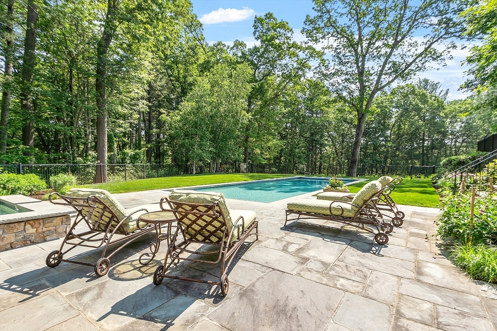 76 Red Coat Lane Concord, MA 01742 - Photo 13 of 42 a view of backyard with swimming pool and outdoor seating