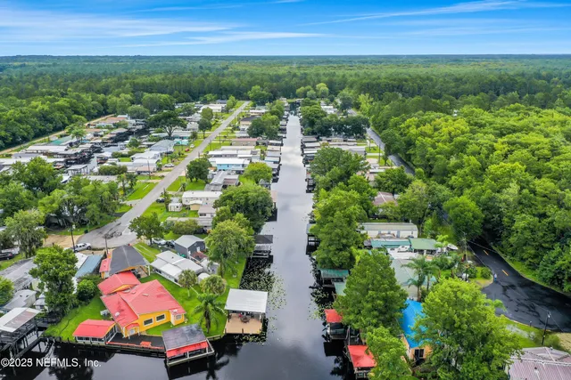 an aerial view of residential houses with yard